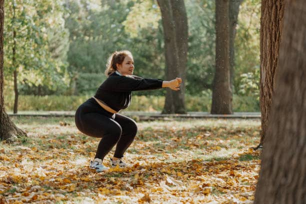 A woman squatting outside